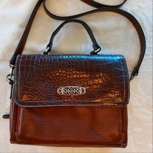 Crossbody, shoulder bag.  Faux leather with silver tone embellishment.